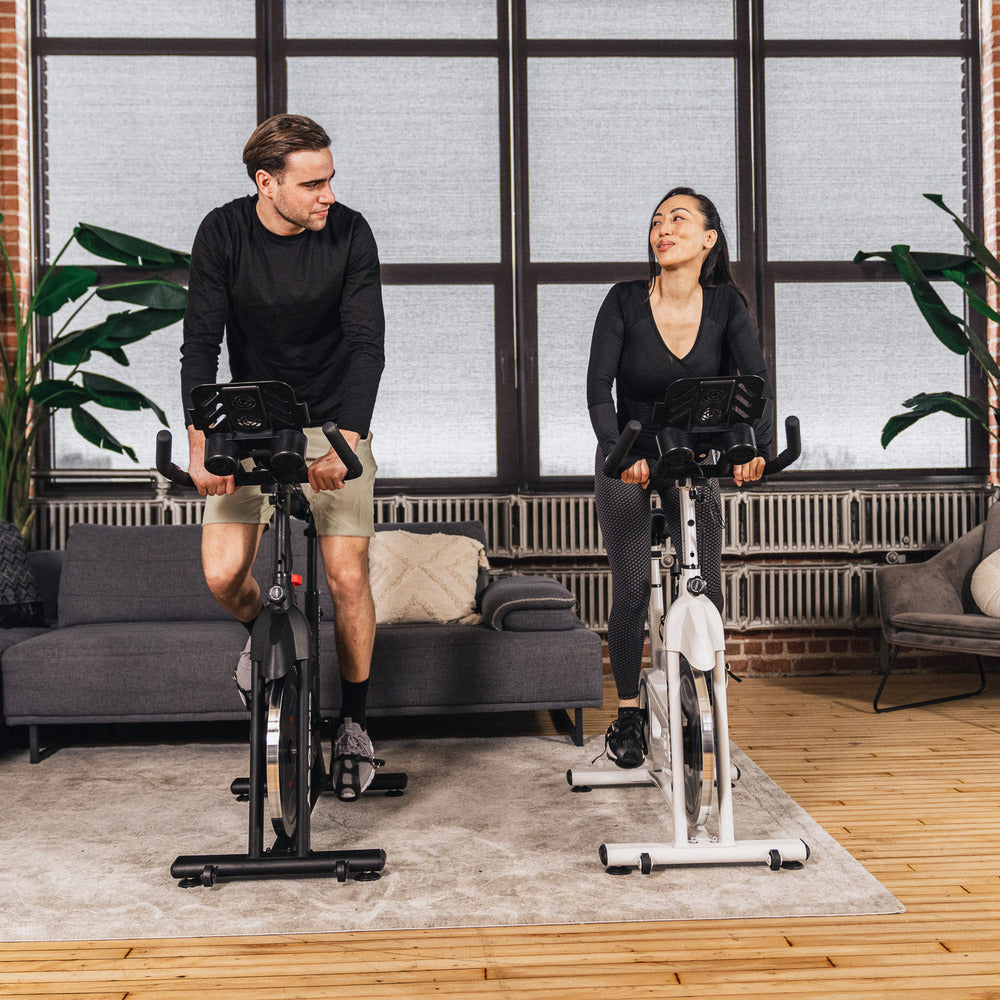 Man and woman on spin bikes